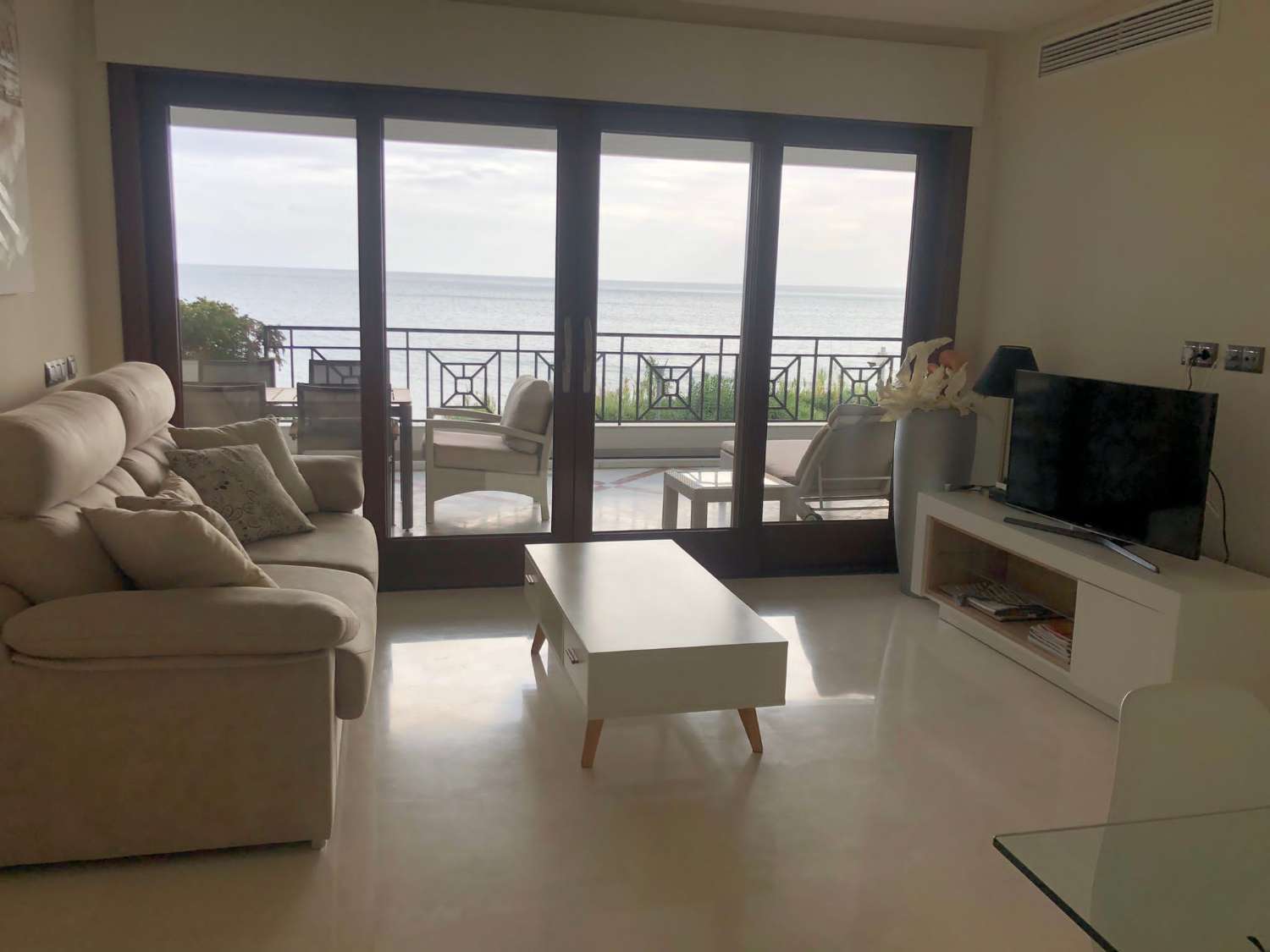 Beachfront home in a luxury gated complex with heated pool, gym, aecurity services.